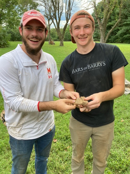 Students holding artifact 