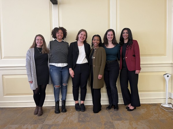 Six Master's of Applied Anthropology students stand for a photo after presenting. 